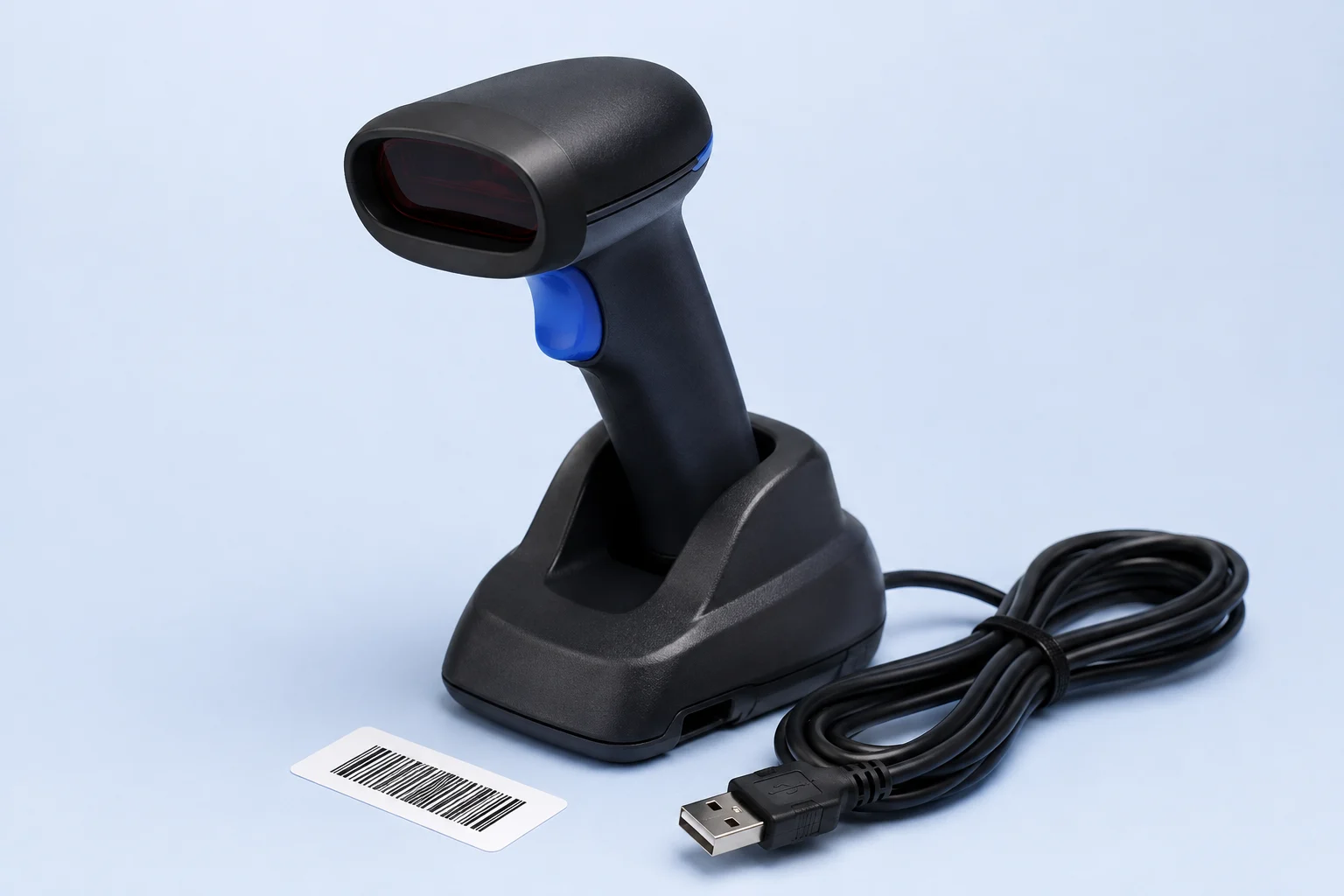 A physical handheld barcode scanner with its cradle and cable.